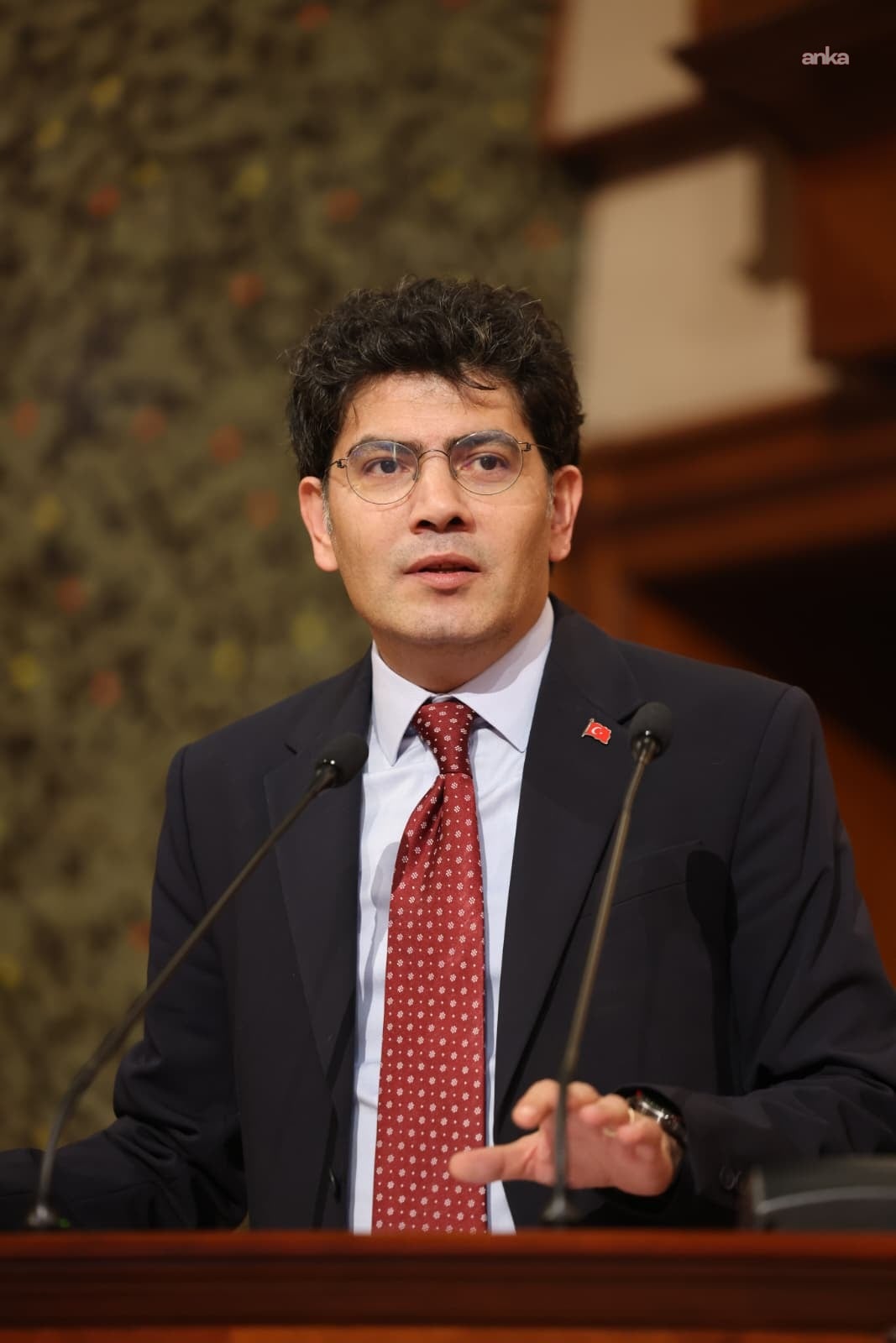 IMM Assembly Member Ahmet Oğuz Demir is seen speaking at the podium.