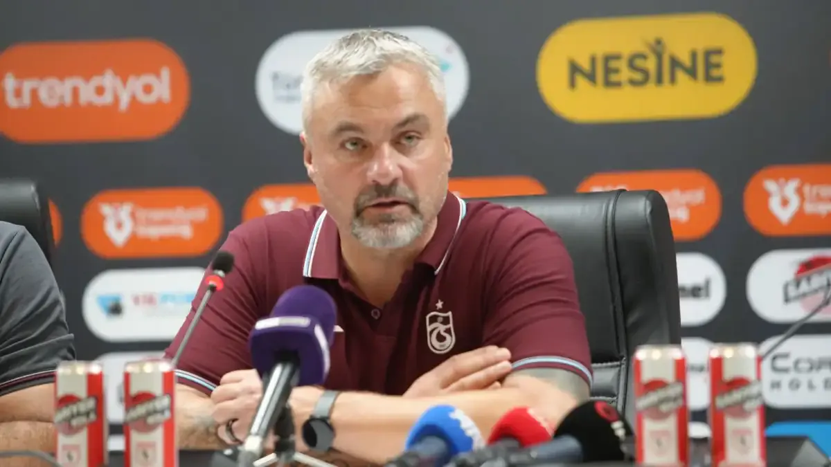 Thomas Reis, basın toplantısında mikrofonların önünde konuşurken görülüyor.
