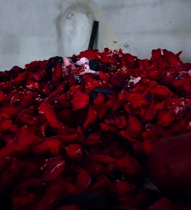 Close-up view of red-colored food products left in the open in the warehouse.