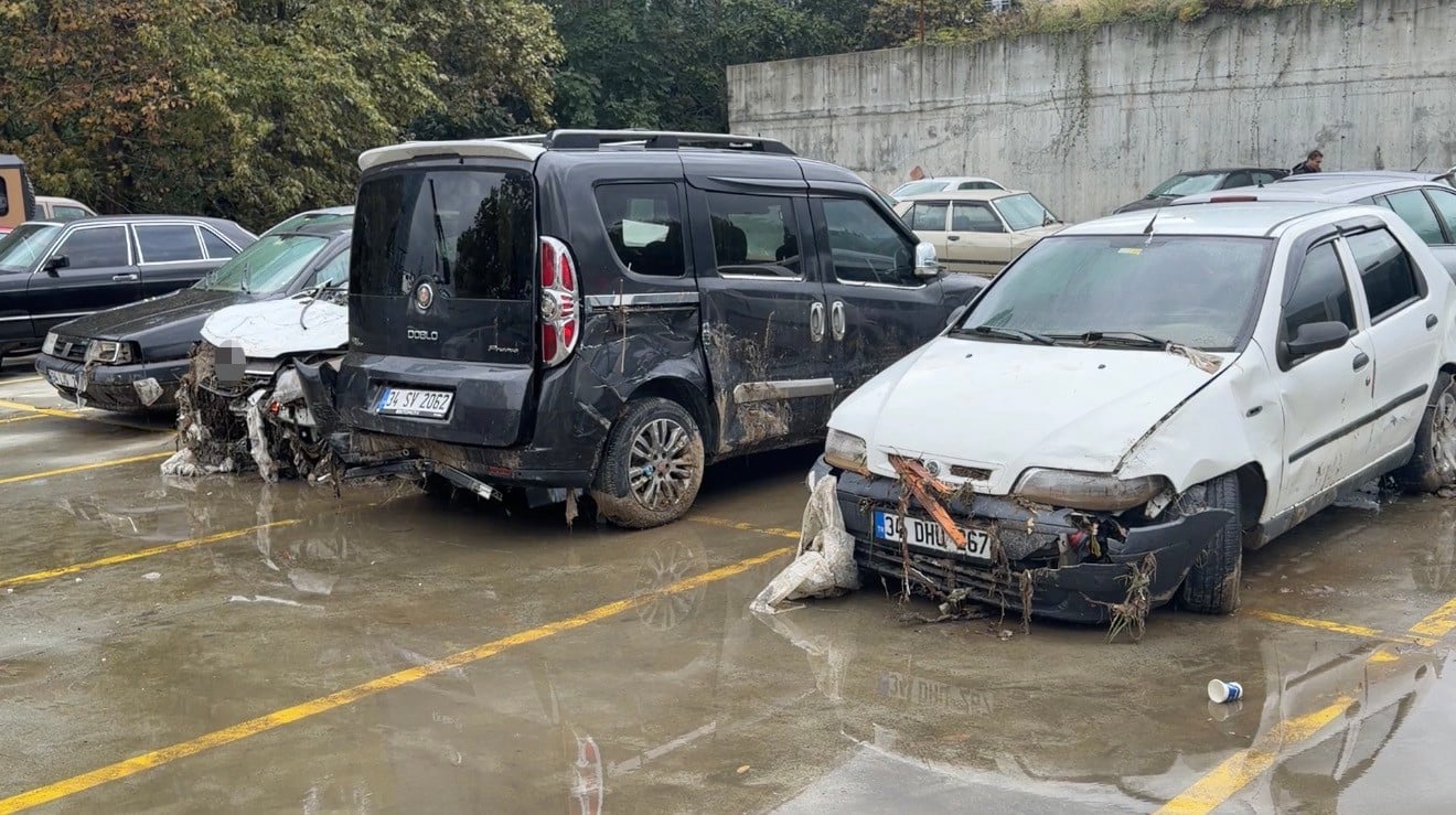 Damaged vehicles waiting in mud and water at the Maslak Parking Lot.