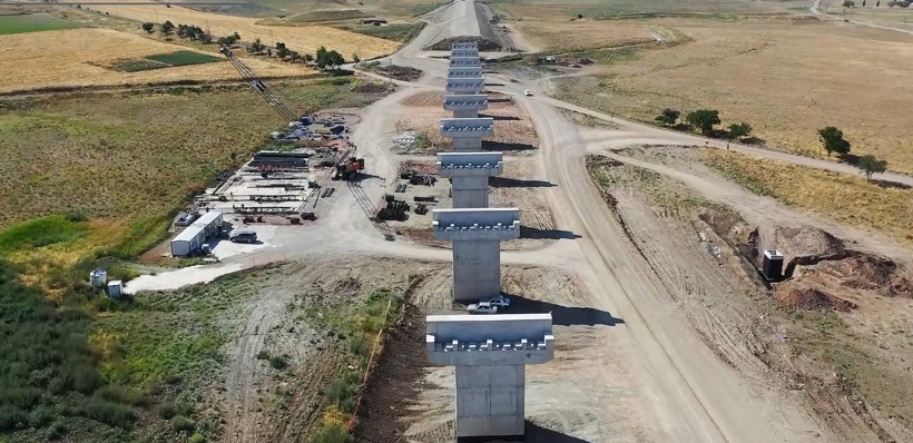 Concrete bridge piers rising in the high-speed train line construction and the construction site area.