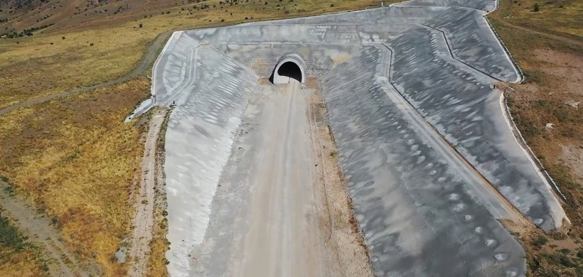A concrete-lined tunnel entrance and construction road on the high-speed train line route.