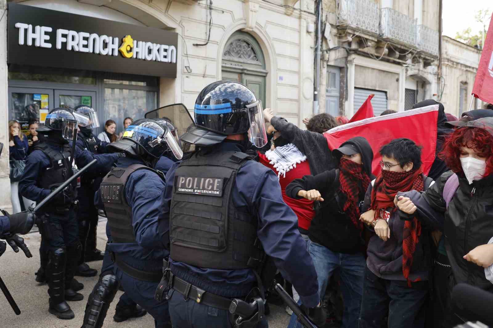 Polis ekipleri ile kırmızı bayrak taşıyan protestocuların karşı karşıya geldiği an görülüyor.