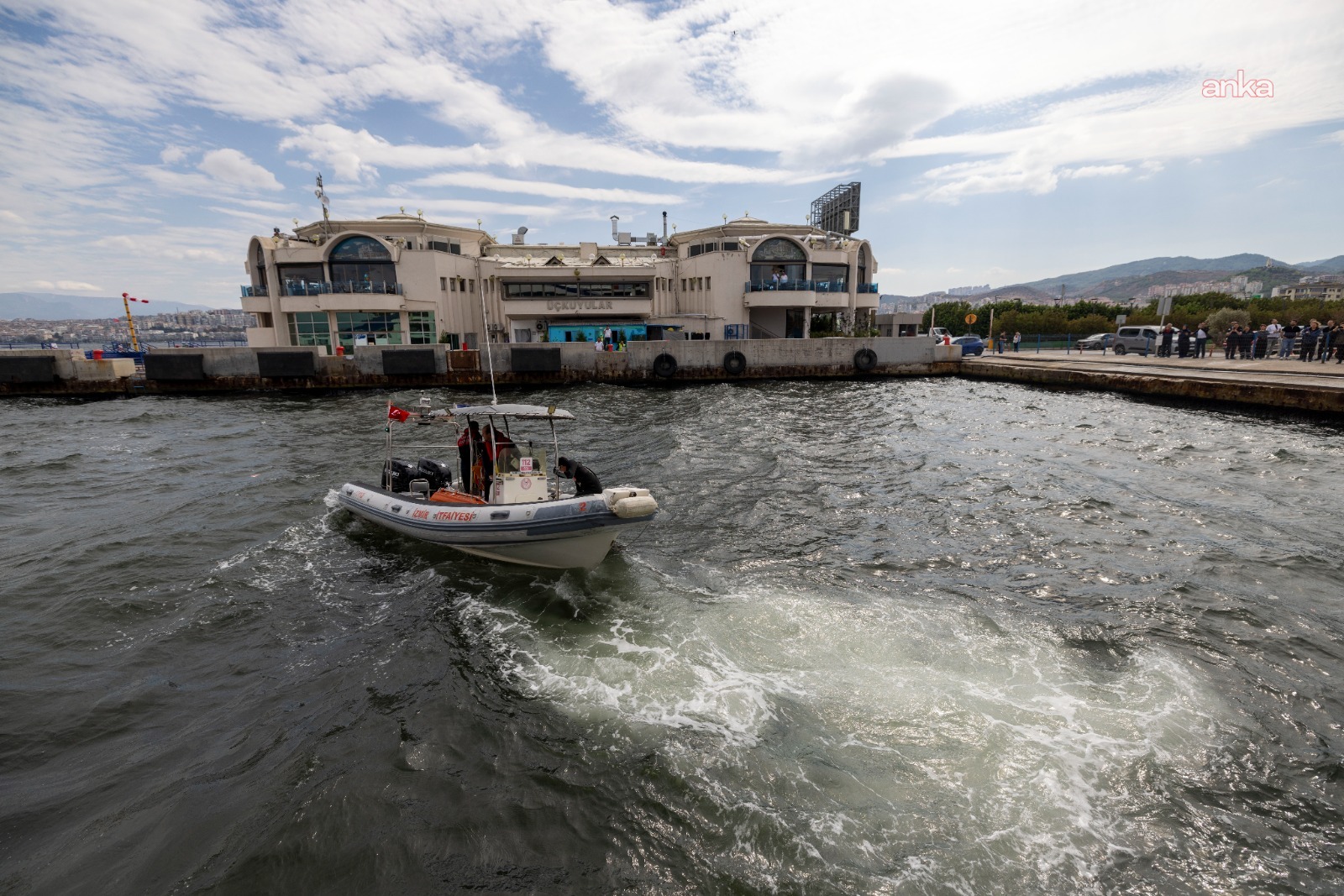 İzmir Fire Department boat moving in front of the Üçkuyular Ferry Terminal.