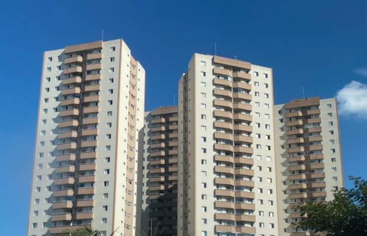 Multi-story apartment blocks under a clear sky.