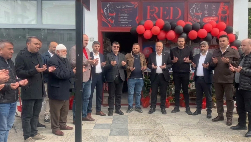 View from the opening ceremony held in front of a lingerie store in Alaca with red and black balloon decorations.