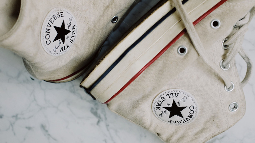 Close-up view of white Converse All Star shoes.