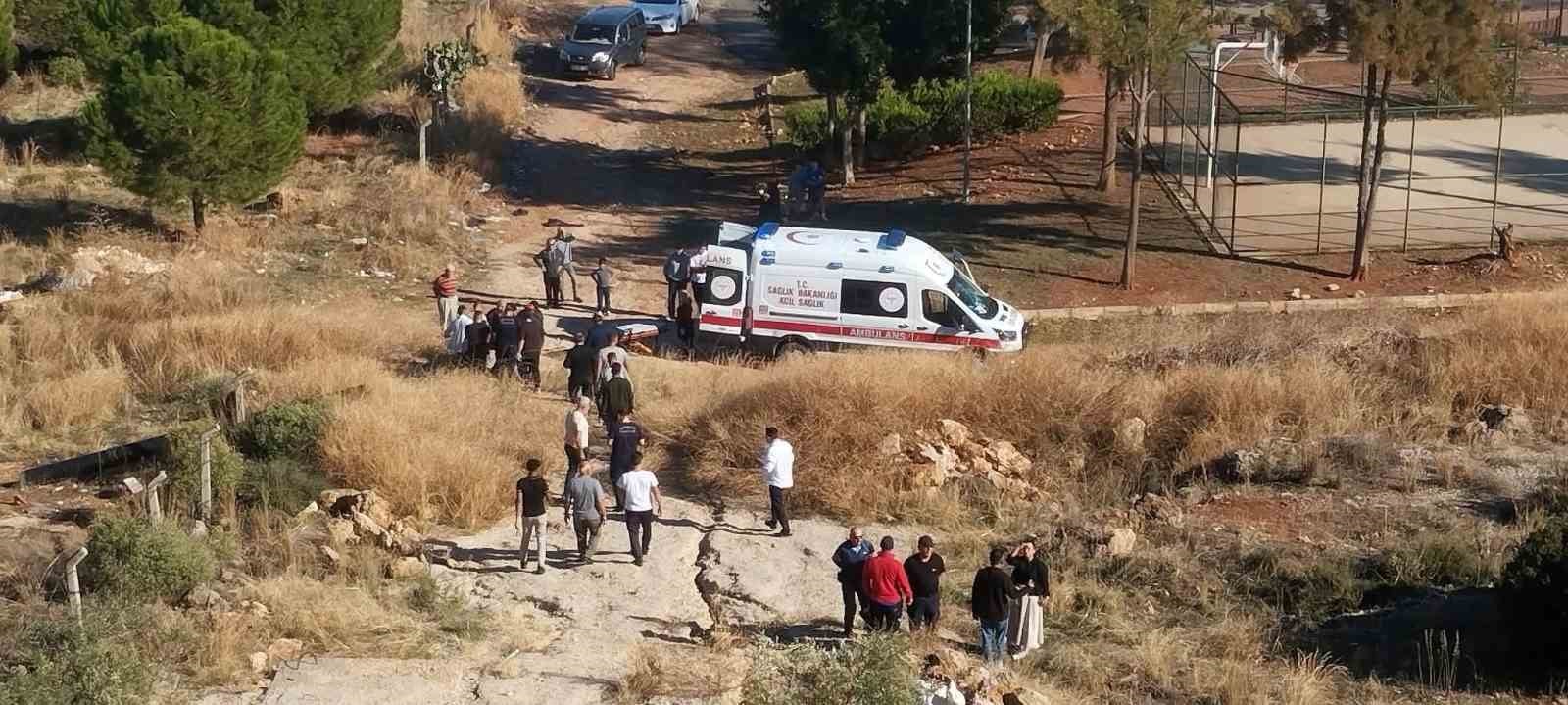 An ambulance and citizens gathered in the area are seen at the accident site in Kepez, Antalya.