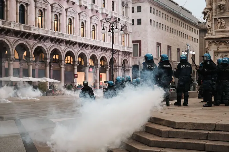 Police teams and a dense cloud of gas are seen around Piazza del Duomo in Milan.
