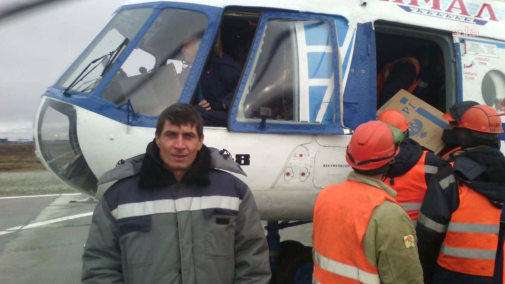 The person identified as Nevzat İnan stands in front of a helicopter in work clothes.