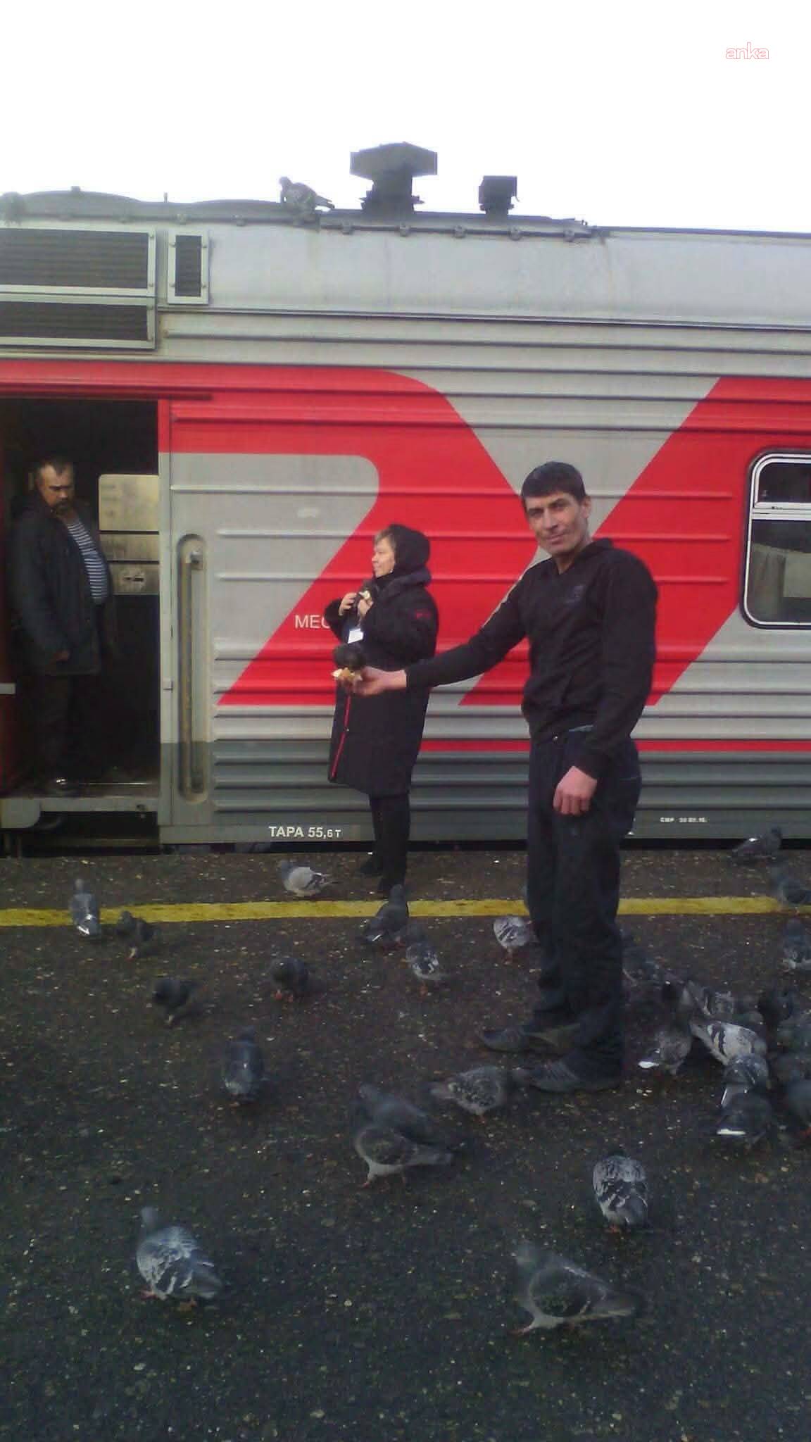 The person identified as Nevzat İnan is seen among pigeons next to a train.