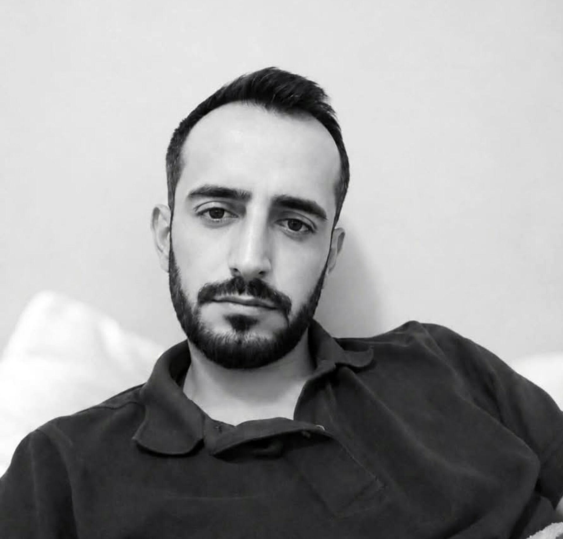 Black and white portrait photo of Aycan Kılınç.