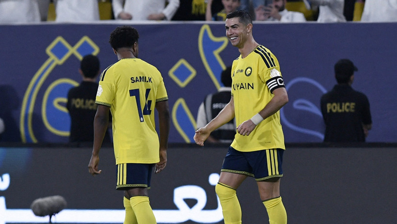 Al Nassr player Cristiano Ronaldo is seen with his teammate during the match.