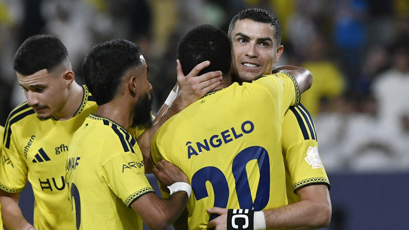 Cristiano Ronaldo is celebrated by his teammates in his Al Nassr jersey.