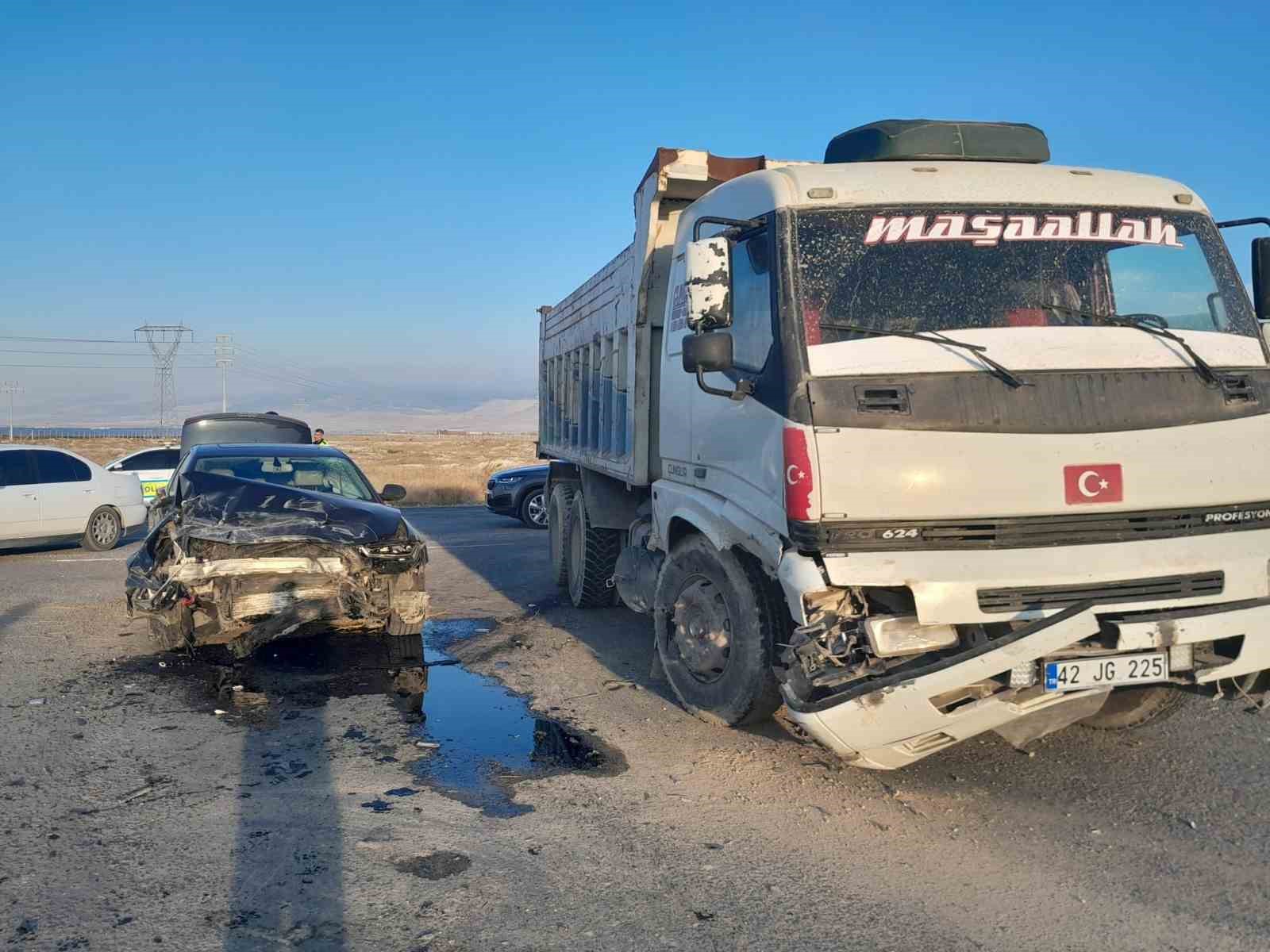 The truck and the damaged car stopped on the side of the road after the accident.