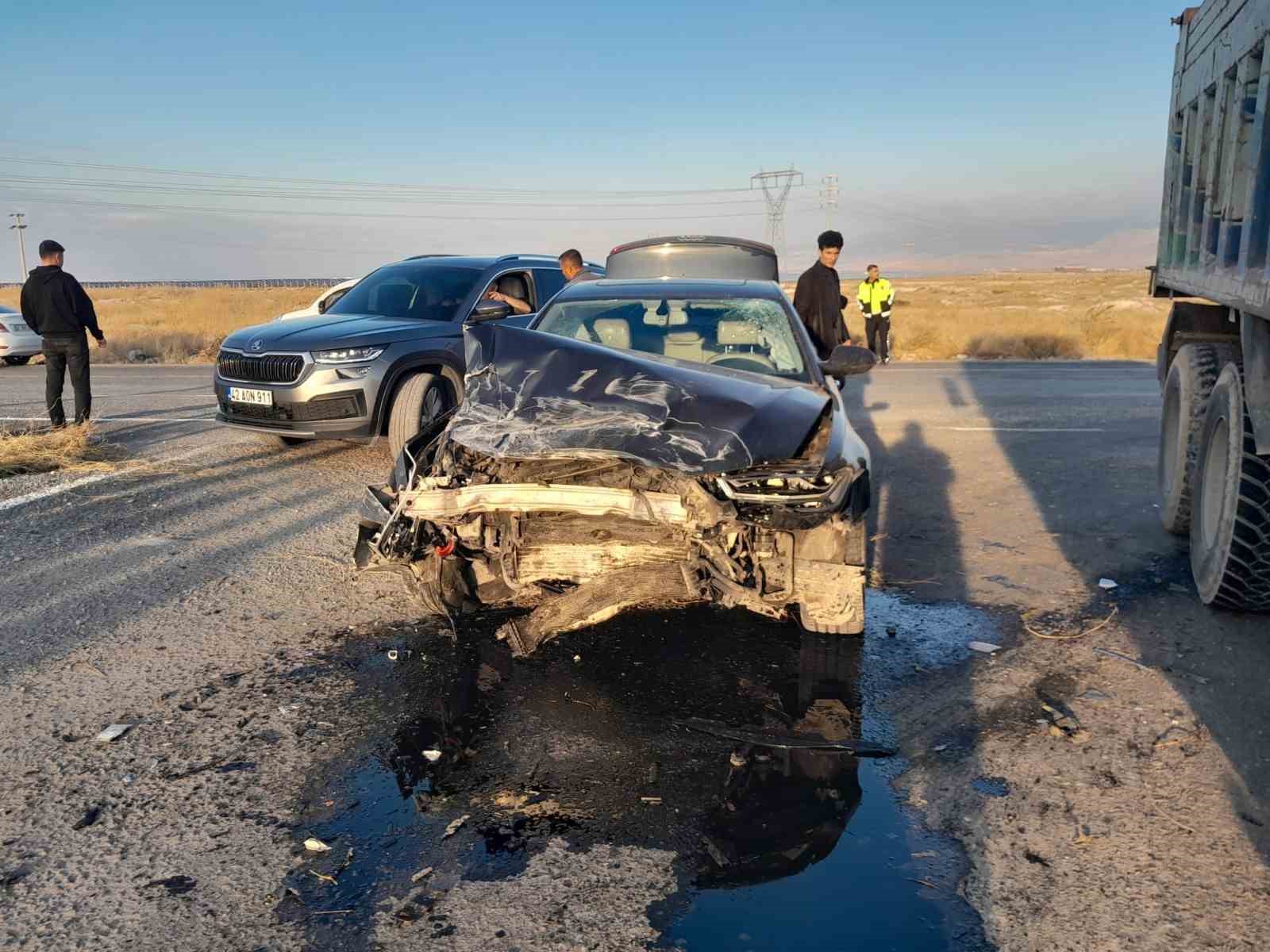 The car with heavy damage to its front and officials at the scene of the accident.