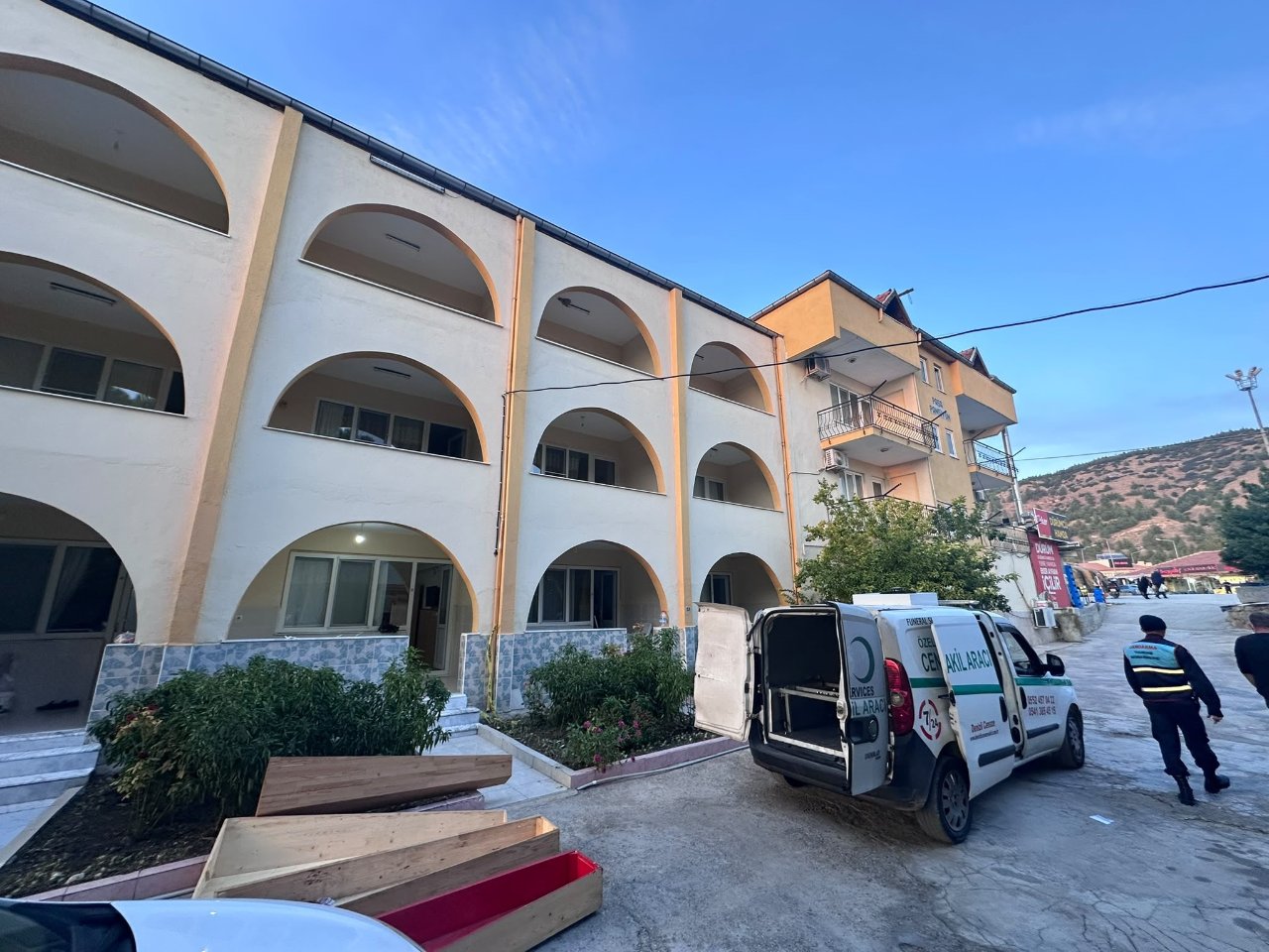 Exterior view of the guesthouse where the incident occurred in Karahayıt neighborhood and a funeral vehicle.