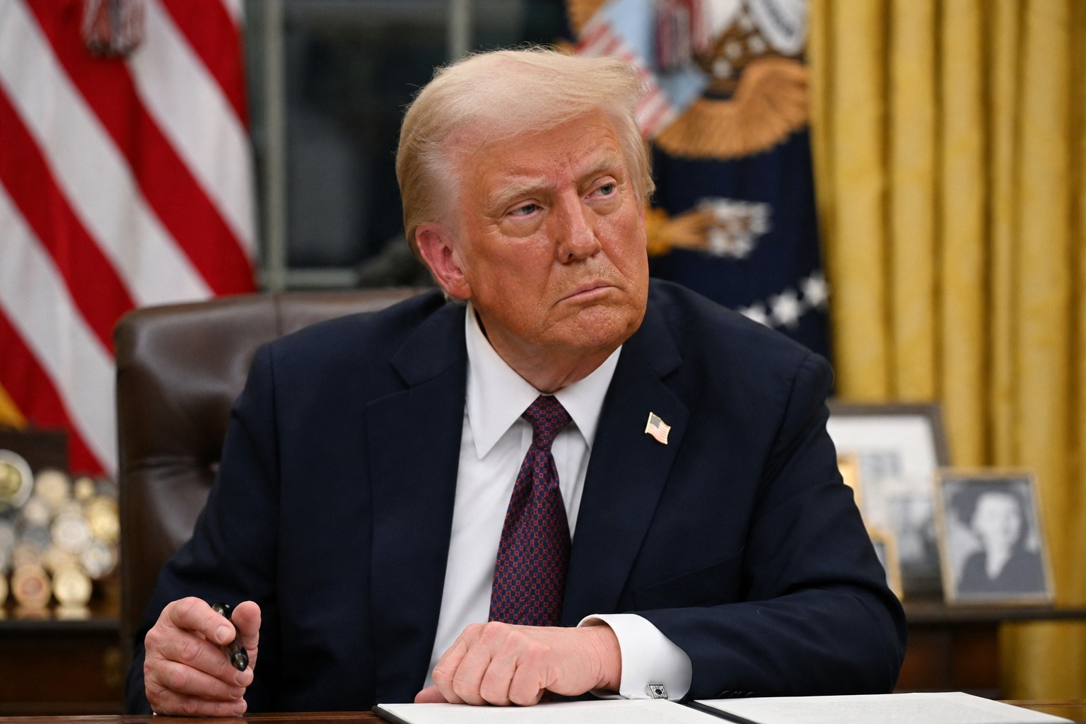 ABD Başkanı Donald Trump Oval Ofis’te masasında otururken görülüyor.