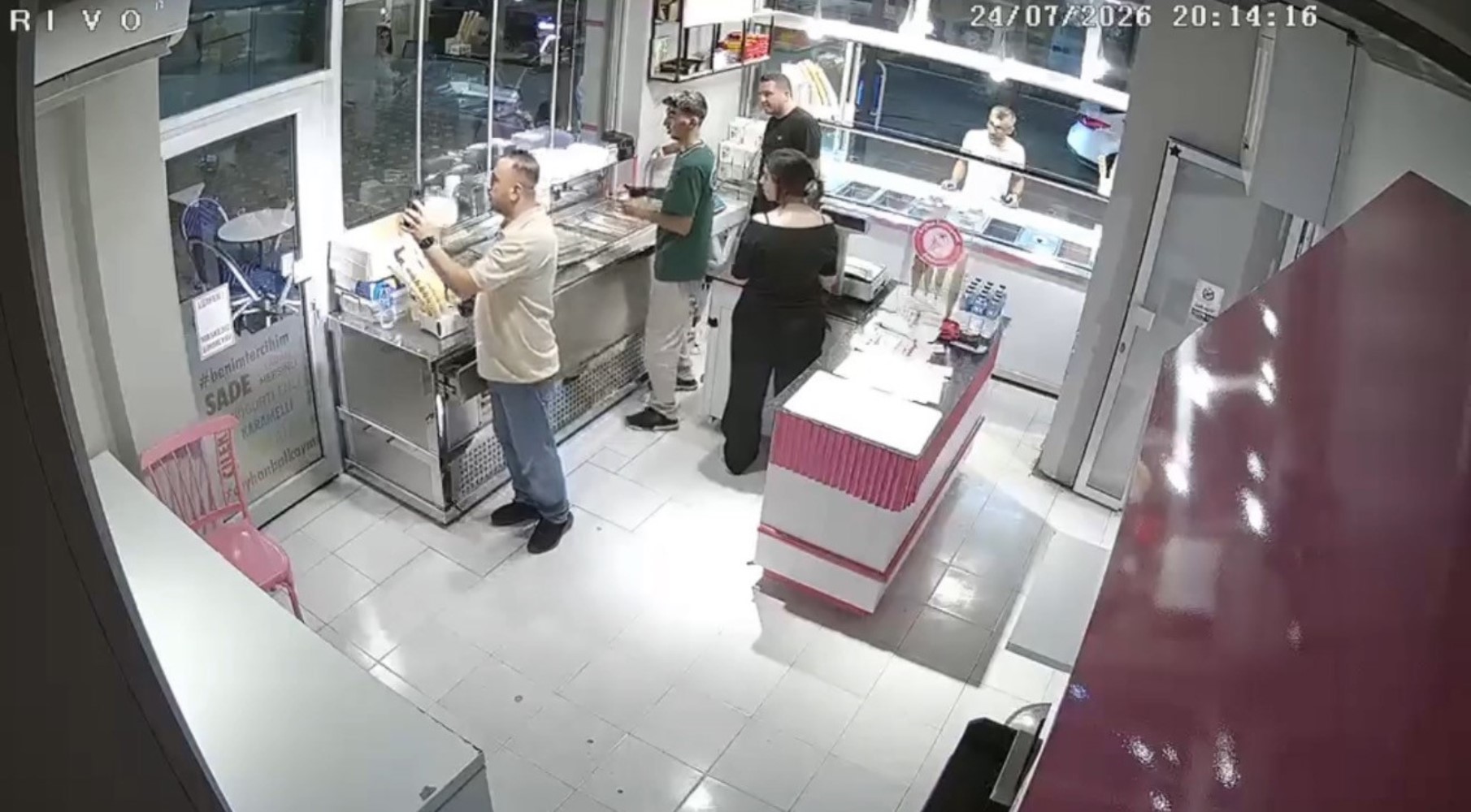 He waved at the person on the mobile phone, then killed the ice cream vendor