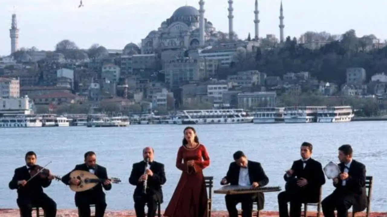 Boğaz kıyısında müzisyenler ve arka planda İstanbul silüeti.