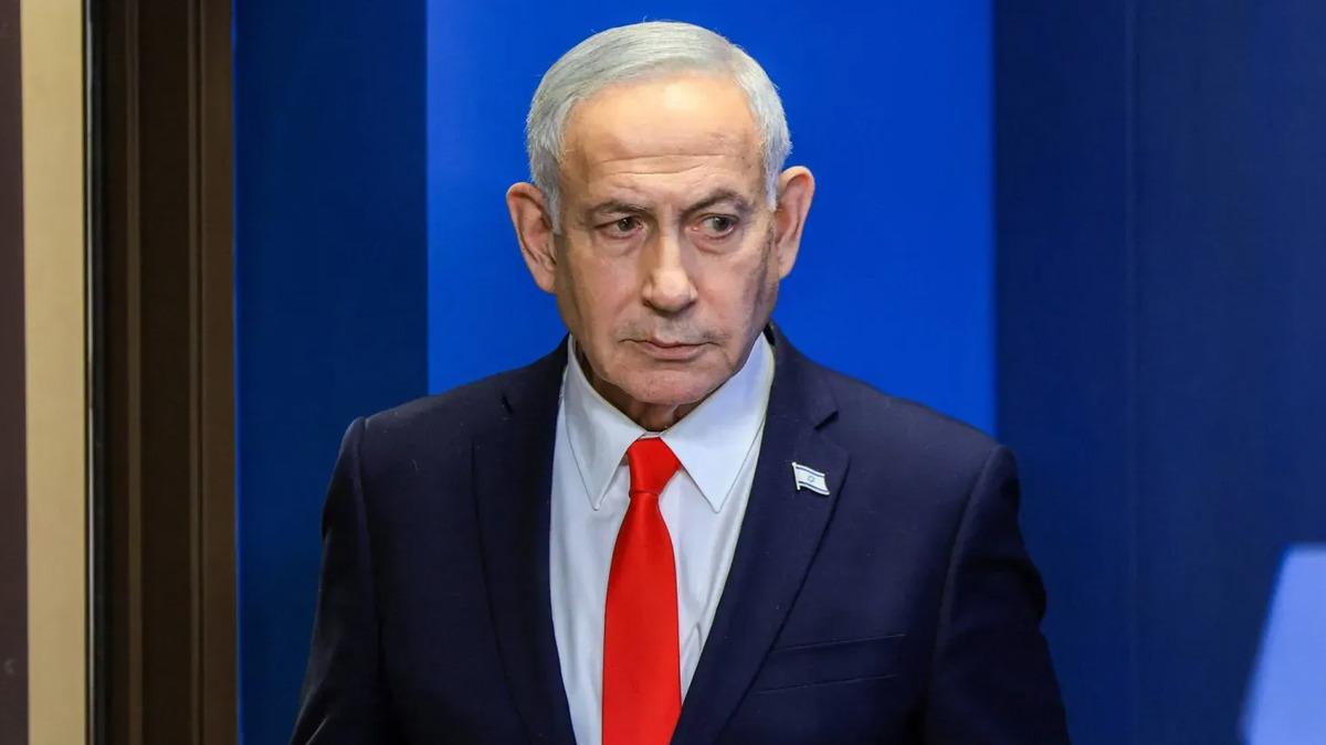 Binyamin Netanyahu lacivert takım elbise ve kırmızı kravatla görülüyor.