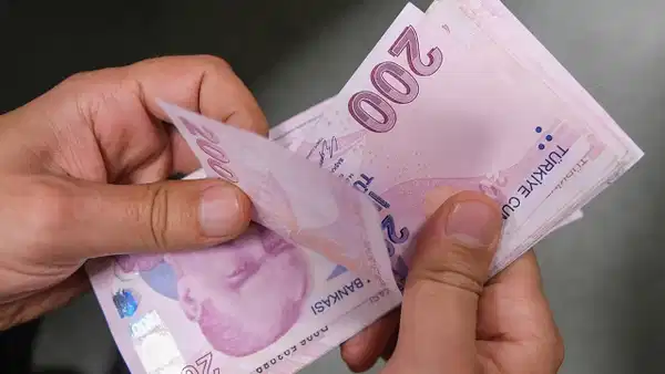 200 TL banknotlarını tutan kişi