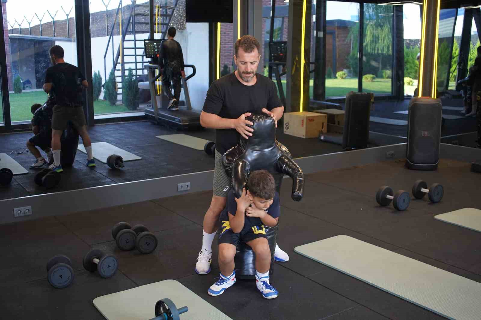 Kürşat Kiraz spor salonunda öğrencisiyle antrenman yaparken görülüyor.