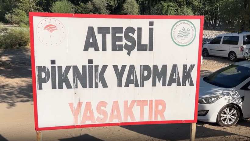 A large warning sign that reads 'Picnicking with fire is prohibited'.