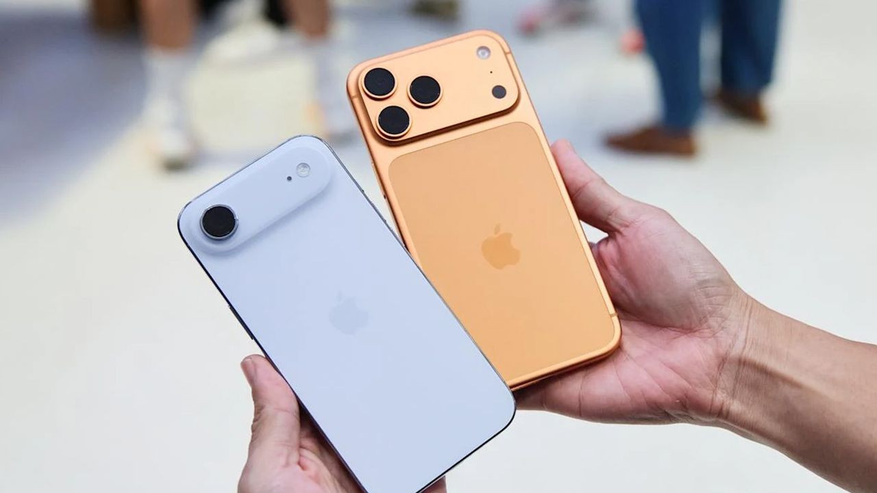 iPhone models in two different colors held in hand.