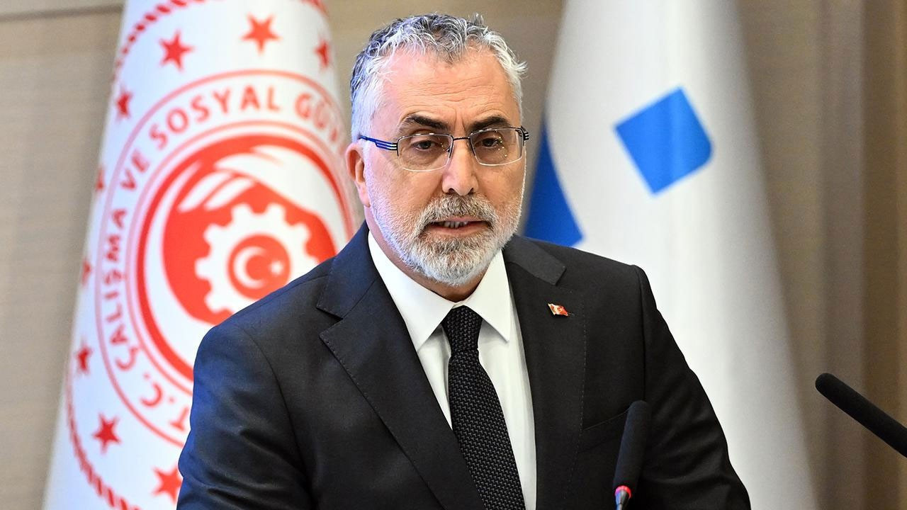 Minister of Labor and Social Security Vedat Işıkhan speaking in front of the ministry emblem.