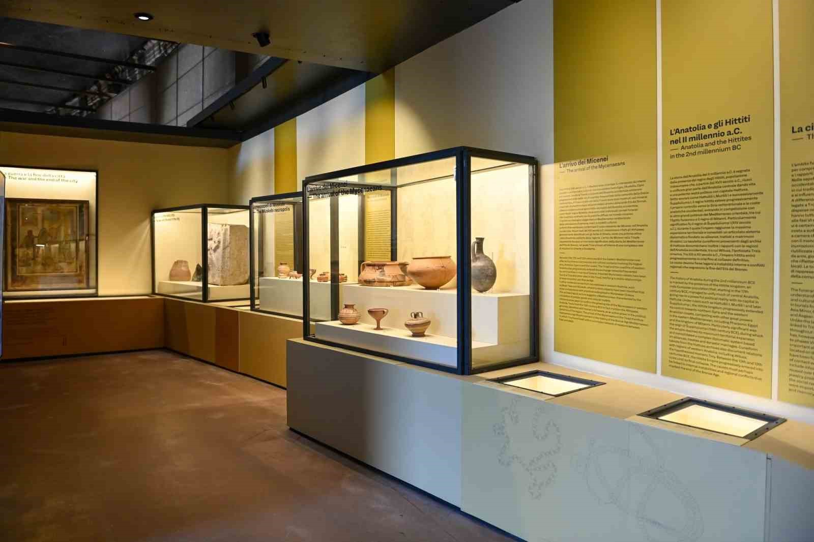 Archaeological artifacts displayed in showcases at the Troy and Rome exhibition at the Colosseum.