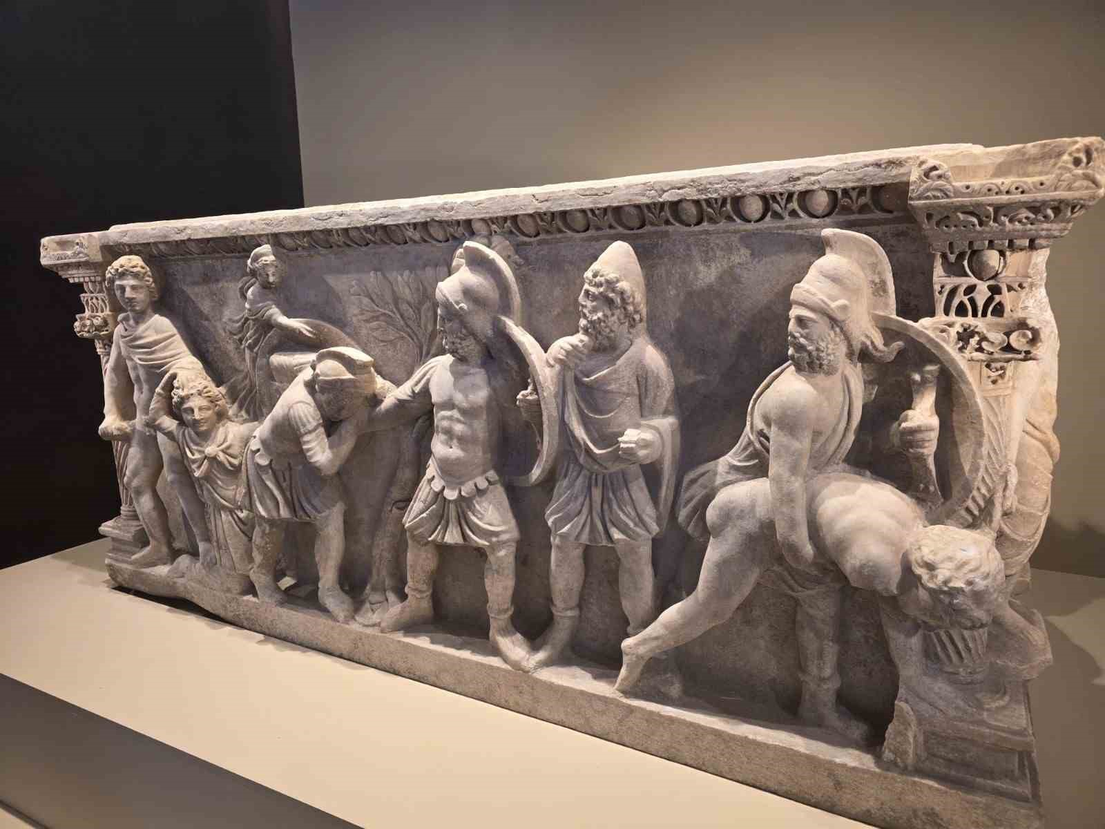 A stone relief featuring ancient figures.