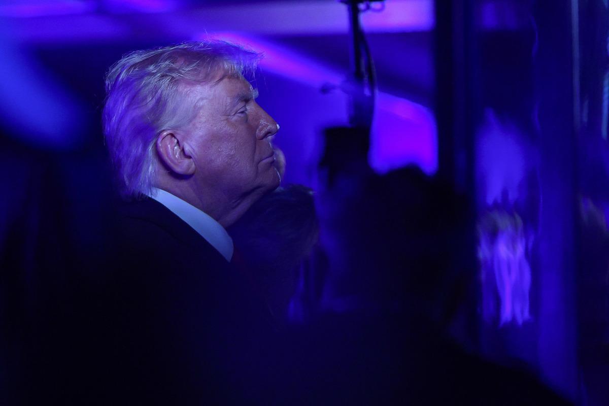 Donald Trump’ın mor ışıklar altında yandan çekilmiş fotoğrafı.