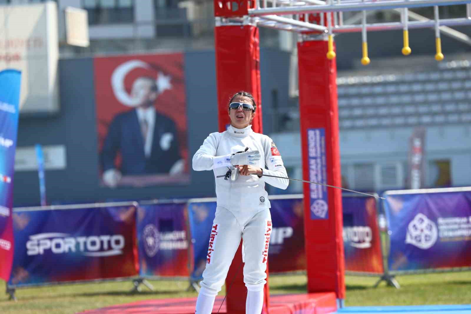 İlke Özyüksel Mihrioğlu, eskrim kıyafetiyle parkurda görülüyor.
