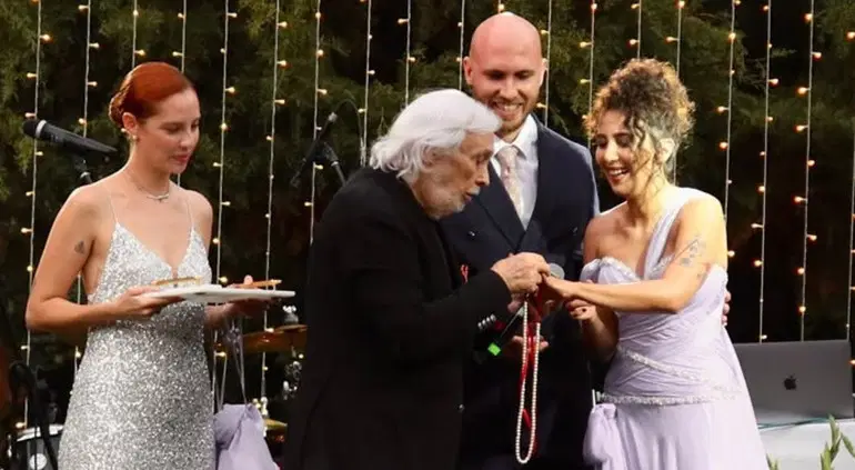 The moment Müjdat Gezen placed the couple's rings at the engagement ceremony.