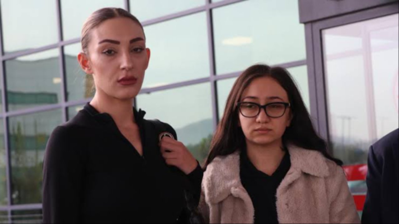 Bina önünde yan yana duran iki kadının görüntüsü.