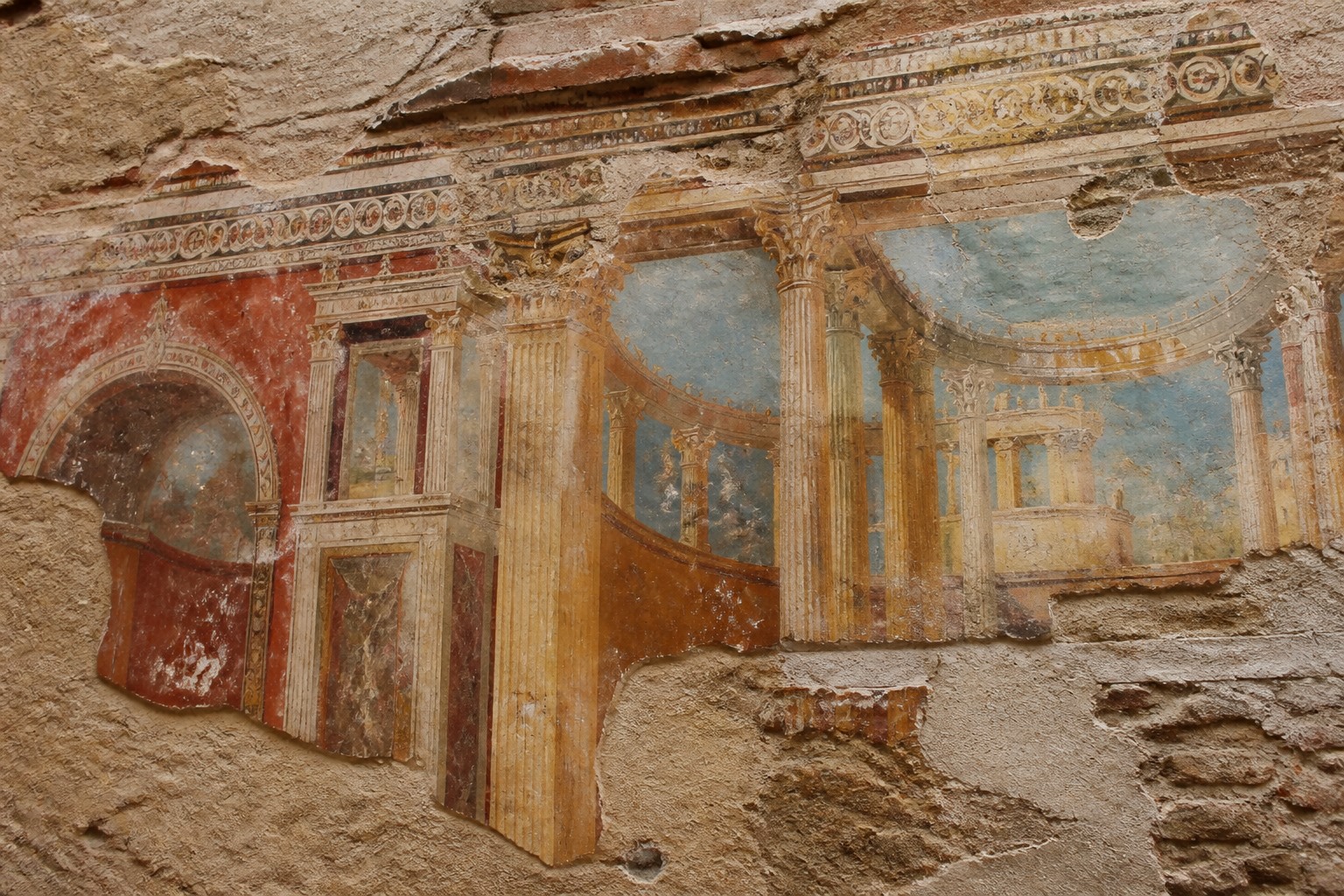 Detail of a fresco or mosaic showing ancient Roman architectural motifs on weathered plaster.