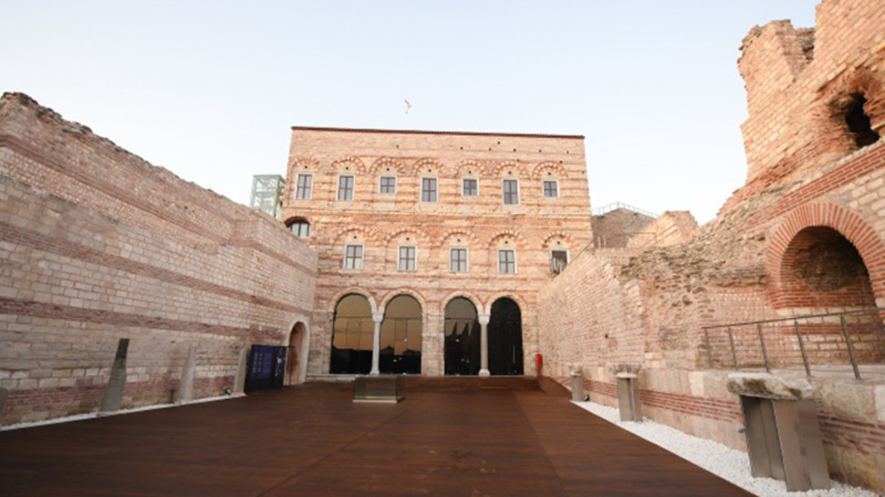 The restored courtyard and brick walls of a historical structure are visible.