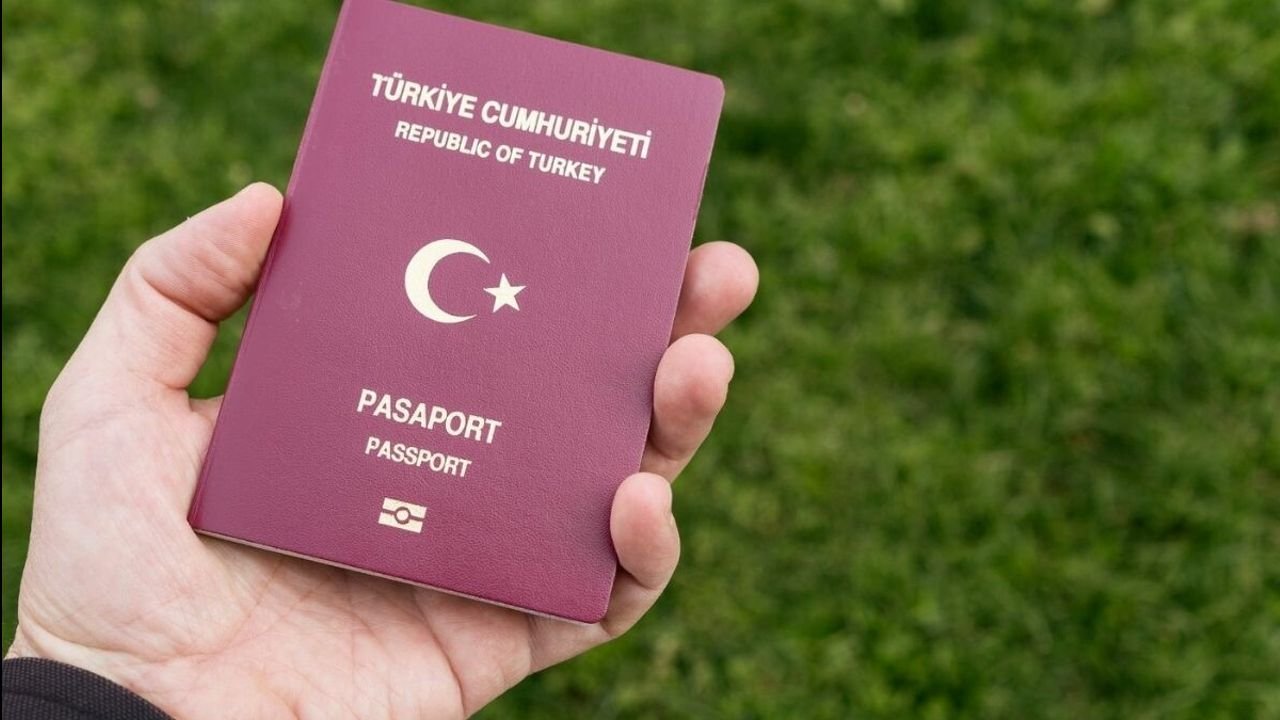 A Republic of Turkey passport held in a person's hand.