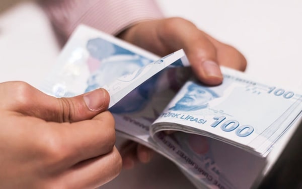 A close-up view of Turkish Lira banknotes being counted.