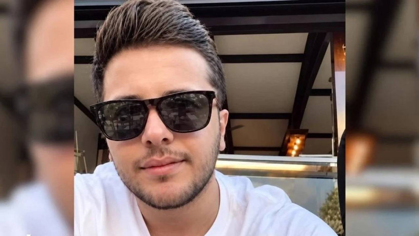 Close-up photo of a person wearing black sunglasses.