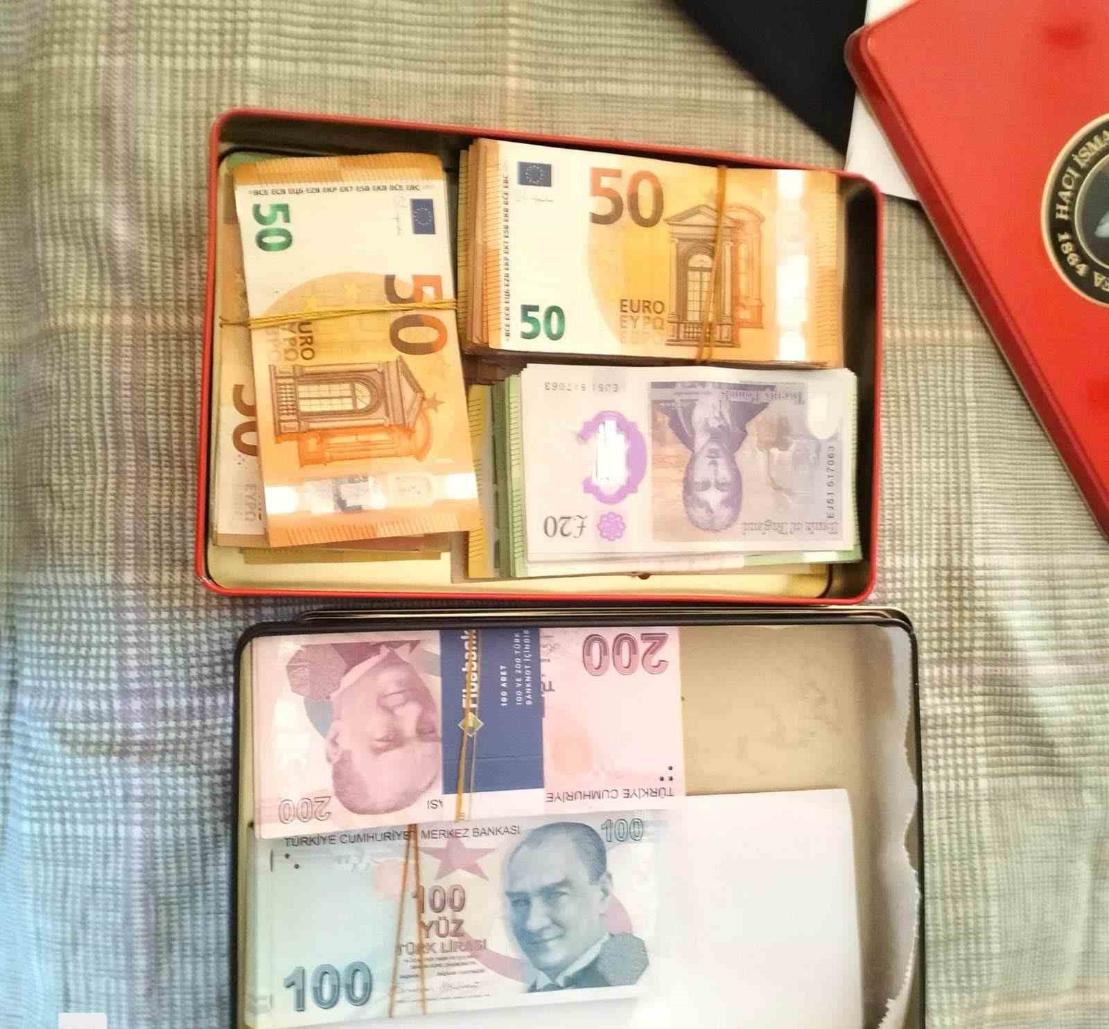 Euro, pound, and Turkish lira banknotes inside boxes.