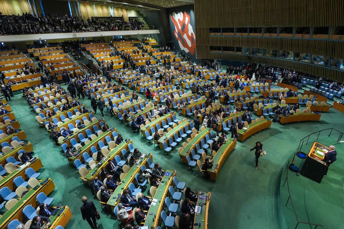 A wide-angle view of the United Nations General Assembly hall with a portion of the delegates leaving.