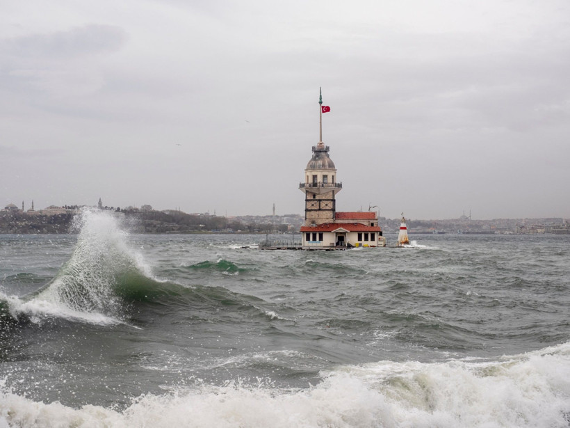 View of the Maiden's Tower under a choppy sea and gray sky.