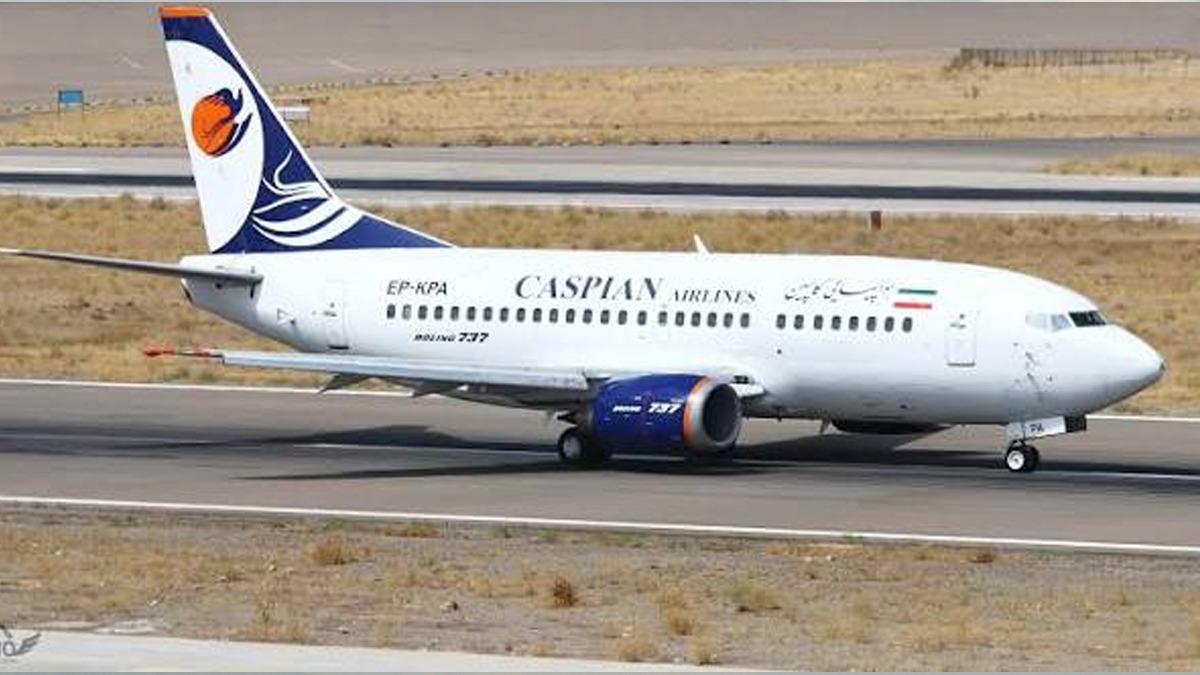 A passenger plane with Caspian Airlines written on it is seen on the runway.