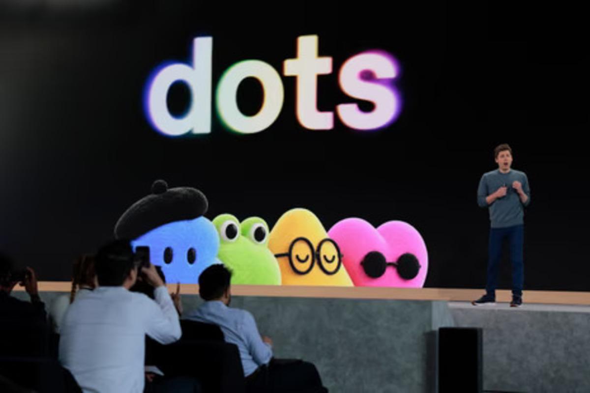 A presentation moment on stage where the word Dots and colorful characters are visible.