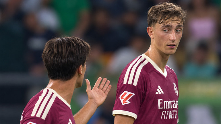 Arda Güler makes a hand gesture towards Dean Huijsen, while Huijsen looks to the side.