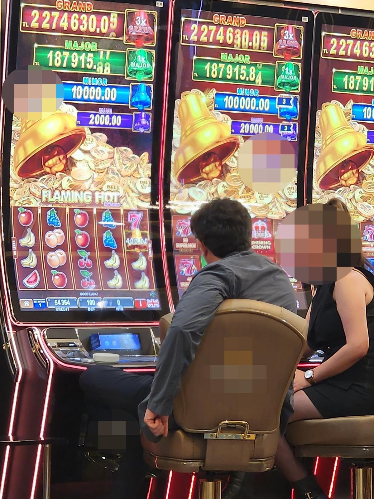 Image showing people sitting in front of casino gaming machines.