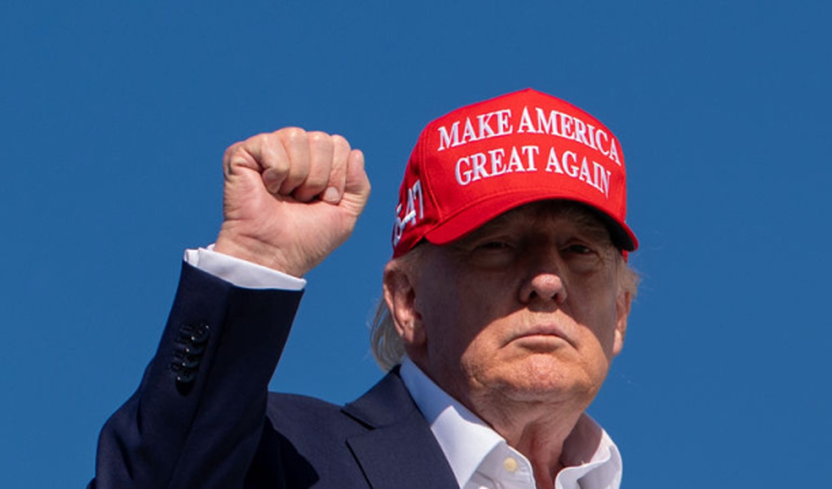 Archive photo of Donald Trump wearing a red hat and raising his fist